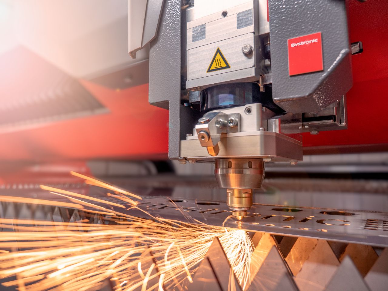 Bystronic laser cutting sheet metal with closeup of cutting head and sparks