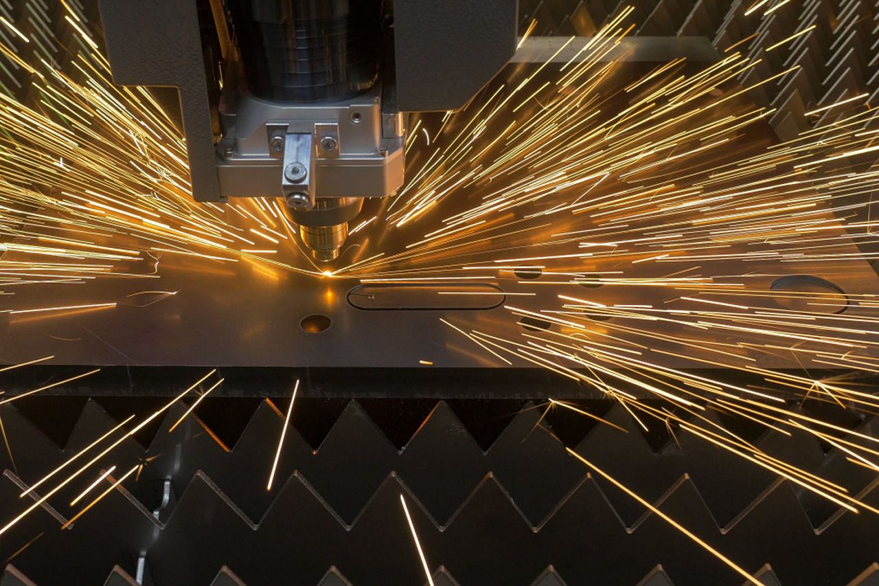 Laser cutting metal with sparks flying