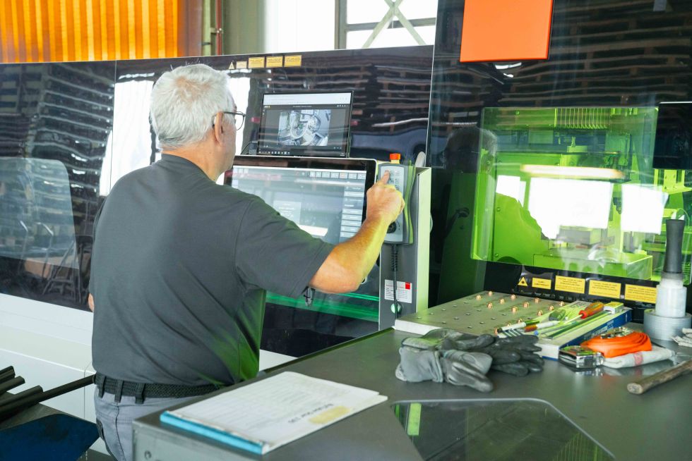 man working on tube machine