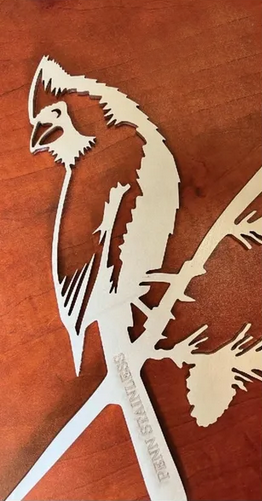 Flat laser cut bird with Penn Stainless' name engraved on it